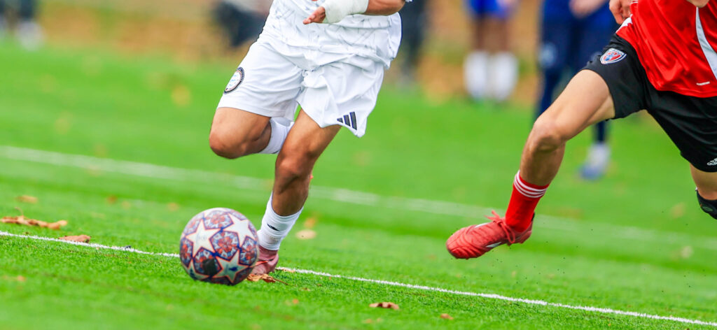 Soccer player dribbling up the field
